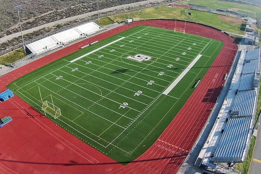Aerial view of a renovated Chaffey high school stadium with synthetic turf and track